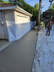 Concrete is poured as part of an alley sewer repair project