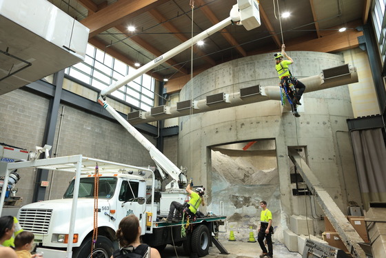 Members of the Forestry Division show off their basket truck and ropes skills at the Public Works Touch-a-Truck event