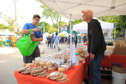 Shopper places produce in a reusable bag at the Oak Park Farmers' Market