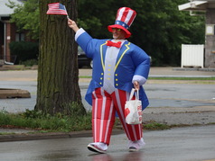 A participant in an inflatable Uncle Sam costume walks in the 2025 Oak Park July 4 parade.