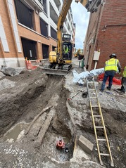 Water main installation in a north south alley as part of the Renew the Avenue construction project