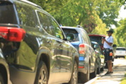 Parking Compliance Specialist Kinita Seals surveys vehicles parked on the street in Oak Park.