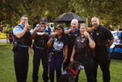 Members of the Police Department with hot dogs at the 2026 National Night Out event at Village Hall.