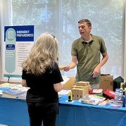 Emergency Preparedness Coordinator Lee Christenson engages with a resident at the Public Health Department Open House on July 30, 2026.