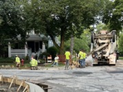 Crews pour concrete for a new curb along Lombard Avenue as part of the 2026 resurfacing project.