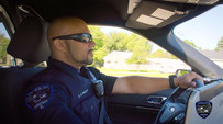 Officer Bailey driving a squad