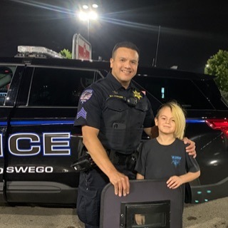 cop with kids outside by truck