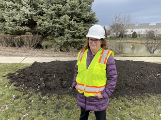 Jennifer Hughes with hard hat at Wolfs Crossing groundbreaking April 2023