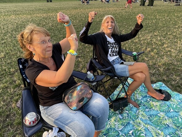 Two women with hands in the air