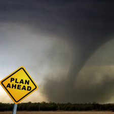 Tornado with "plan ahead" road sign