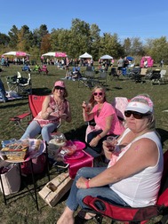 Wine Off Fox 2022 3 women glasses wearing pink tents background 