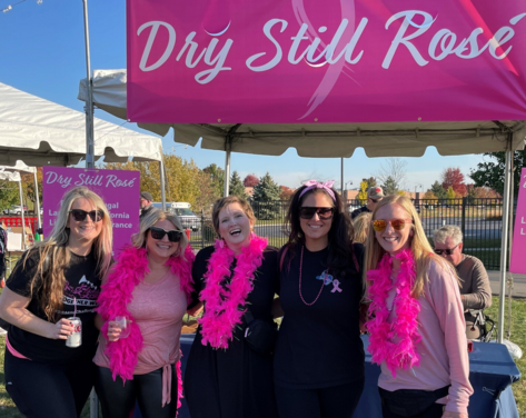 Breast cancer group of survivors wine tent background crop 