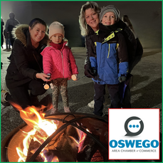 Family smores roasting at old Chamber office Christmas Walk 2022 crop 2024