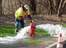  A public works worker opening a fire hydrant to conduct hydrant flushing.