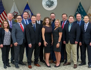 Current elected officials posing in the Municipal Building chambers.