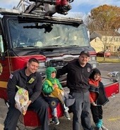 kids trick or treat at fire truck