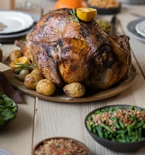 Turkey on a table set for thanksgiving.