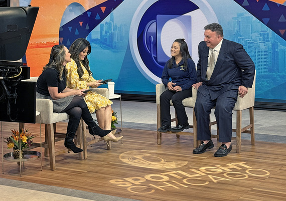 Police officer joins two talk show hosts from WGN on stage to film a live interview in studio.