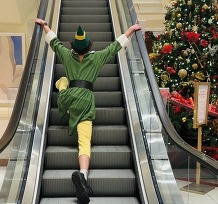 Buddy the Elf rides escalator up to second floor