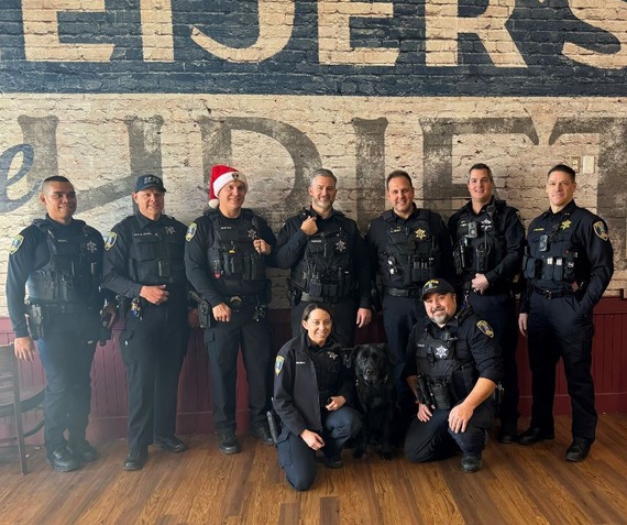 Nine cops and the K-9 unit pose for a group shot at the Meijer's Store.