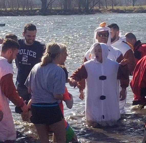 Participants and first responders looking cold as they wade into the Fox River.