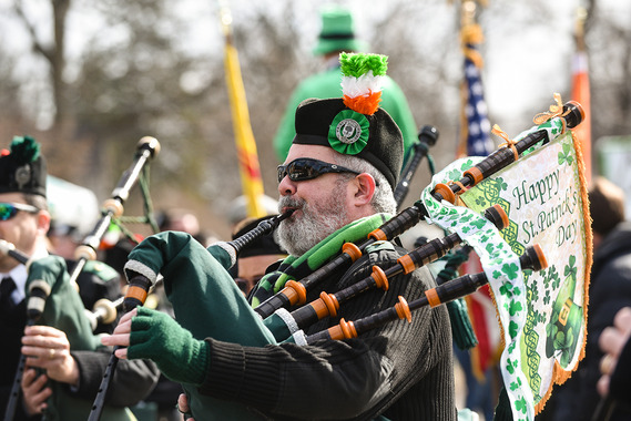A bagpiper walking in the parade.