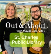 Two people standing side by side in a library