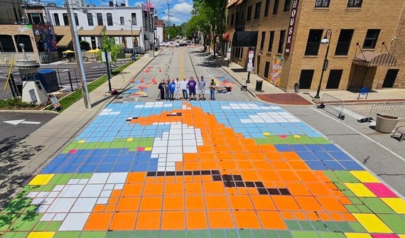 A large colorful fox is painted on the roadway.