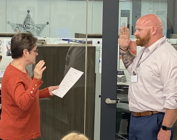 An officer is sworn in at the police station.