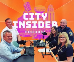 The Mayor, Fire Chief and Police Commander sit in a podcast room with the show hosts.