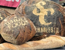 Baked bread with the St. Charles, Illinois and Whole Foods baked into the top layers.