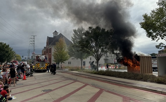 A rescue demonstration of a live fire in front of a crowd during the Open House event.