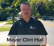 Mayor Hull delivering messaging while standing on the side of a newly paved Prairie Street.