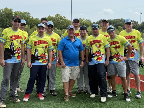 11 baseball players stand alongside Mayor Clint Hull.