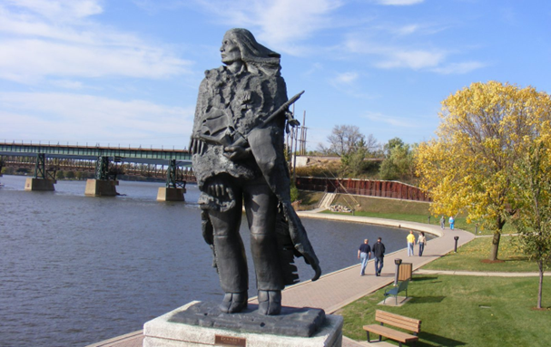 Ekwabet Native American Sculpture looks out over the Fox River.