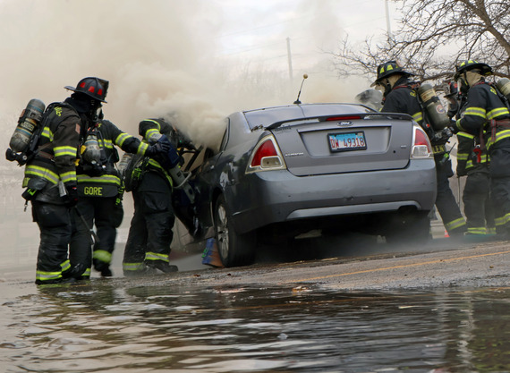 A group of firefighters puts out EV fire.