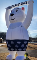 A polar bear holding a polar plunge sign up