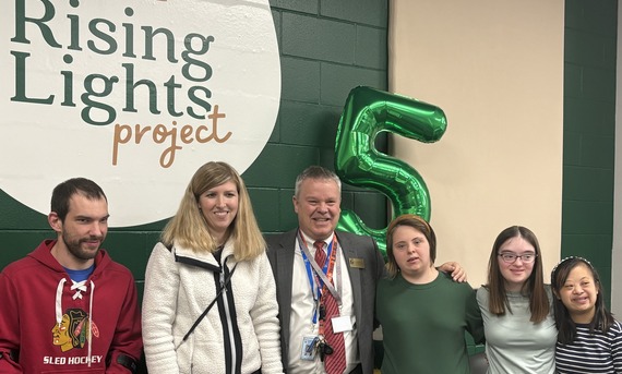 The Mayor stands next to participants of the Rising Lights Project.