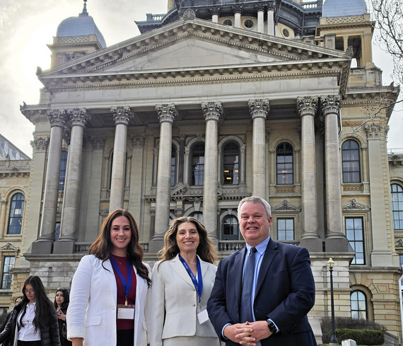 CA Heather McGuire, Alderperson Jayme Muenz and Mayor Hull stand in front of a government building in Springfield, Illinois.