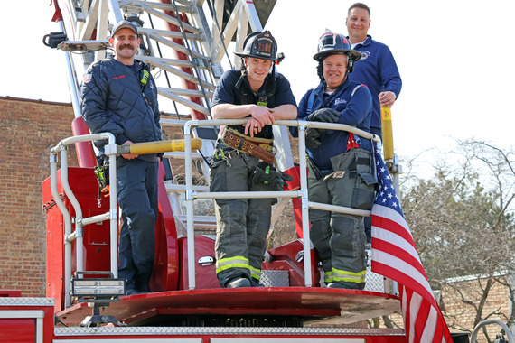 Mayor dress in a firefighter uniform while on a rig during a ride-along with the Fire Department.