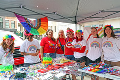 A vendor participates in Pride Fest with staff wearing Pride colors.