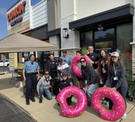 Cops and members of Special Olympics Illinois pose outside of a Dunkin' for Cop on a Rooftop event.