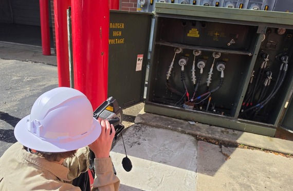 An Electric Engineering intern uses a device to conduct a thermography inspection