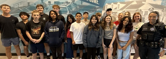Students gather for a photo at the police department for the youth police academy.