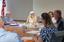 Commission members conduct a meeting at the Municipal Building.
