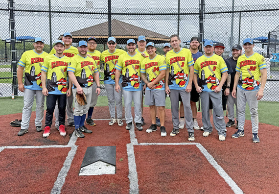 Softball team members pose for a photo during a softball tournament. The players are from the St. Charles Police Department.