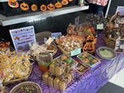 Baked goods decorated for Halloween on a purple tablecloth.