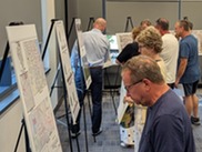 Residents look at boards with plan ideas for the Campton Hills Road bike lanes.
