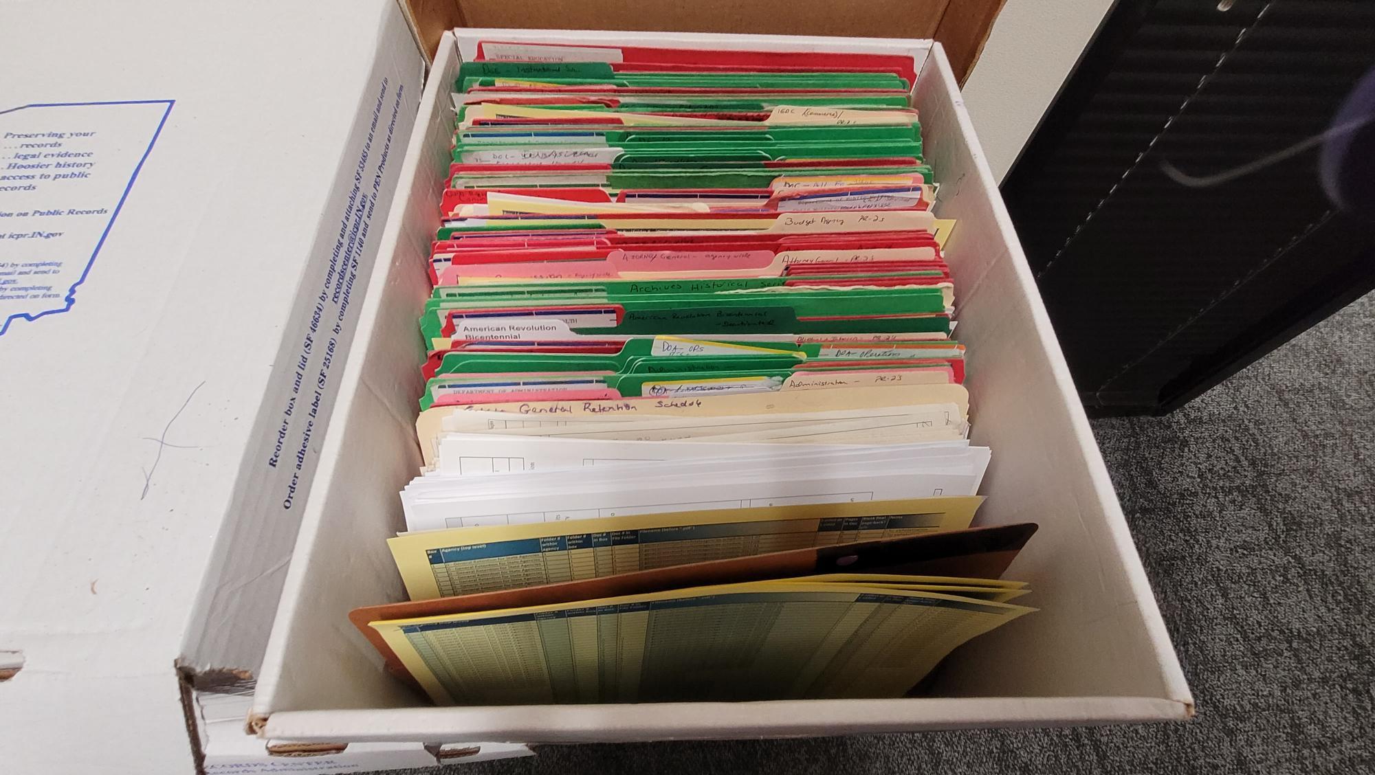 File box filled with red and green folders