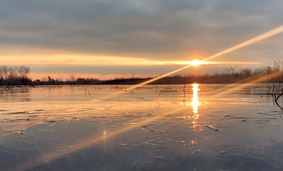 Sunrise over an icy lake